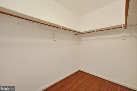 an empty room with a fan and a window
