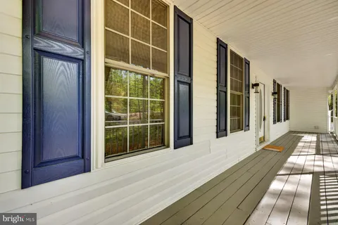 a kitchen with stainless steel appliances granite countertop a table chairs sink refrigerator and microwave