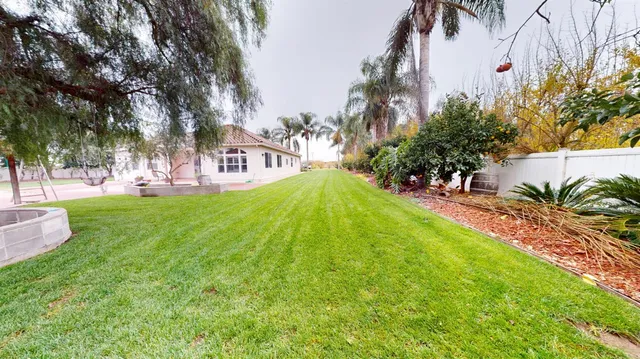a swimming pool with outdoor seating and yard