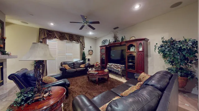 a living room with furniture a flat screen tv and a fireplace