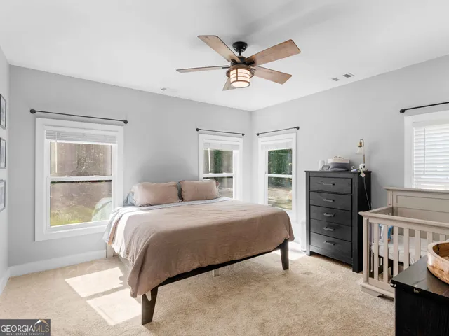 a bedroom with a bed dresser and a window