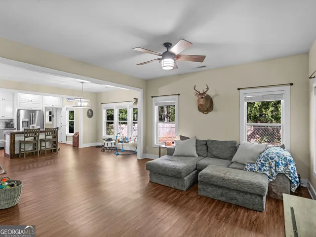a living room with furniture and wooden floor