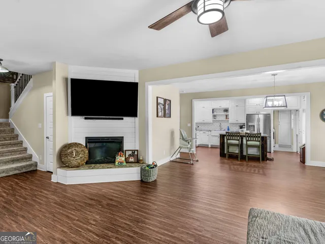 a living room with furniture a fireplace and a flat screen tv