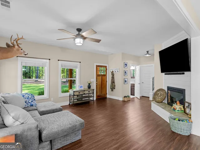 a living room with furniture and a flat screen tv