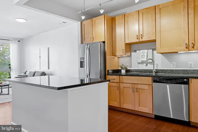 a living room with furniture and a dining table with kitchen view