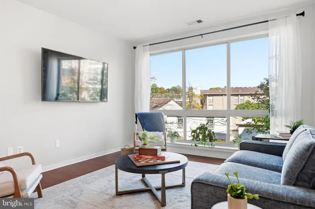 a bed room with a bed and a large window