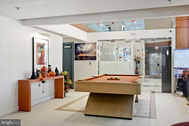 a room with lots of furniture and a potted plant