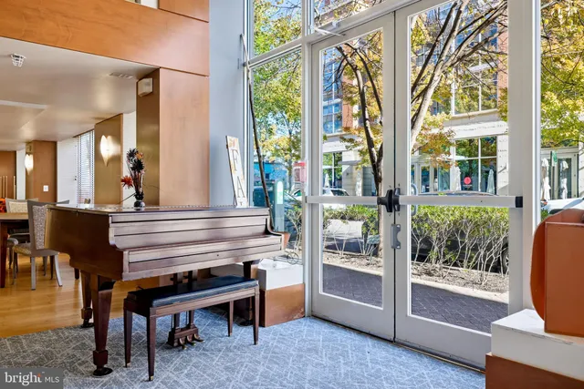 a view of a patio with table and chairs potted plants and a large tree