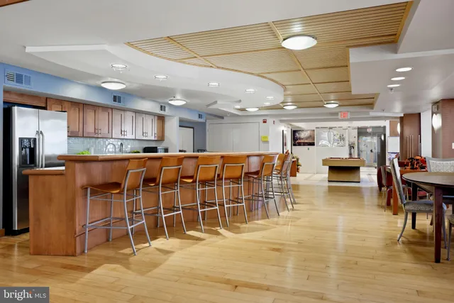 a view of a hallway with closet and wooden floor