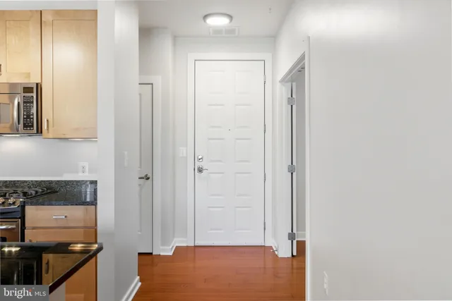 a kitchen with a refrigerator a sink and cabinets