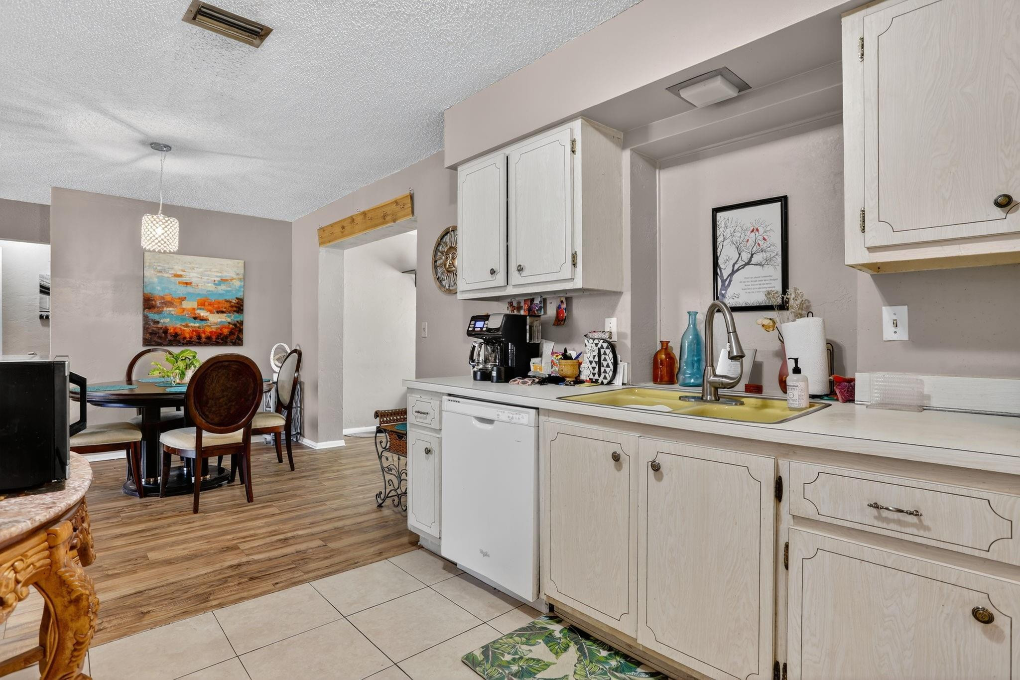 9806 Northwest 71st Street Tamarac, FL 33321 - Photo 12 of 23 a kitchen with granite countertop a sink cabinets and stainless steel appliances