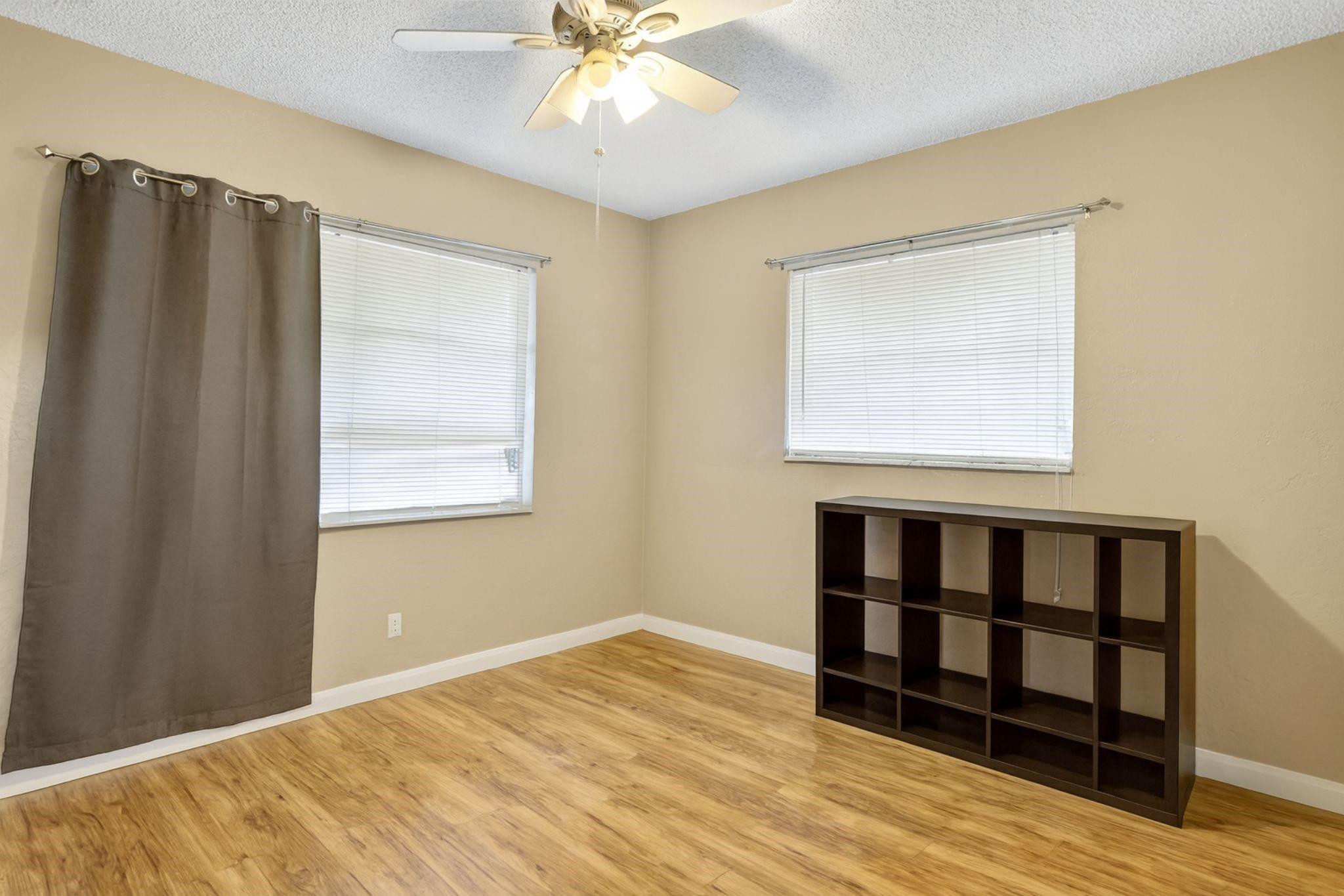 9806 Northwest 71st Street Tamarac, FL 33321 - Photo 16 of 23 a view of an empty room with wooden floor and a window