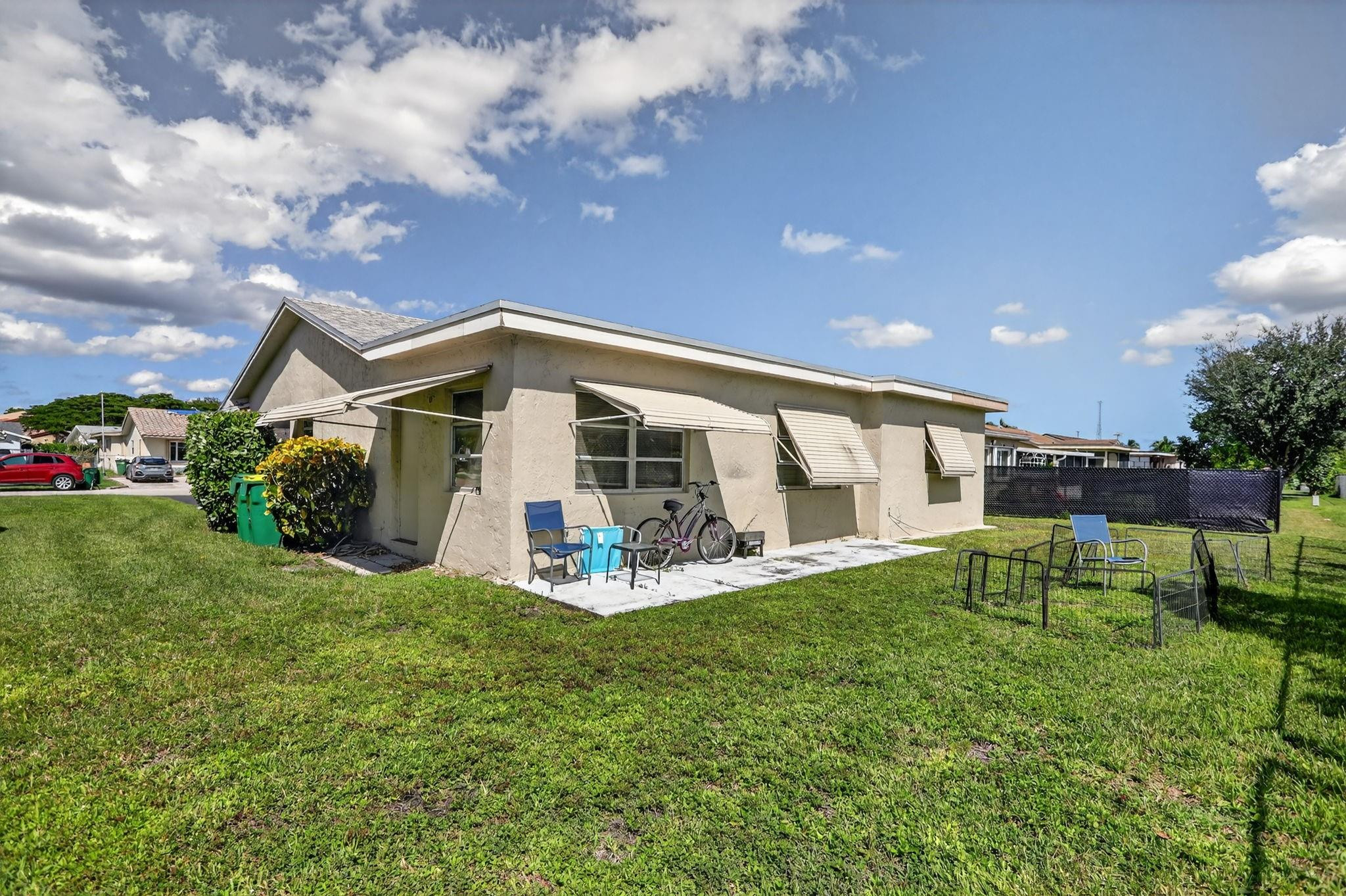 9806 Northwest 71st Street Tamarac, FL 33321 - Photo 21 of 23 a view of a house with a yard and sitting area