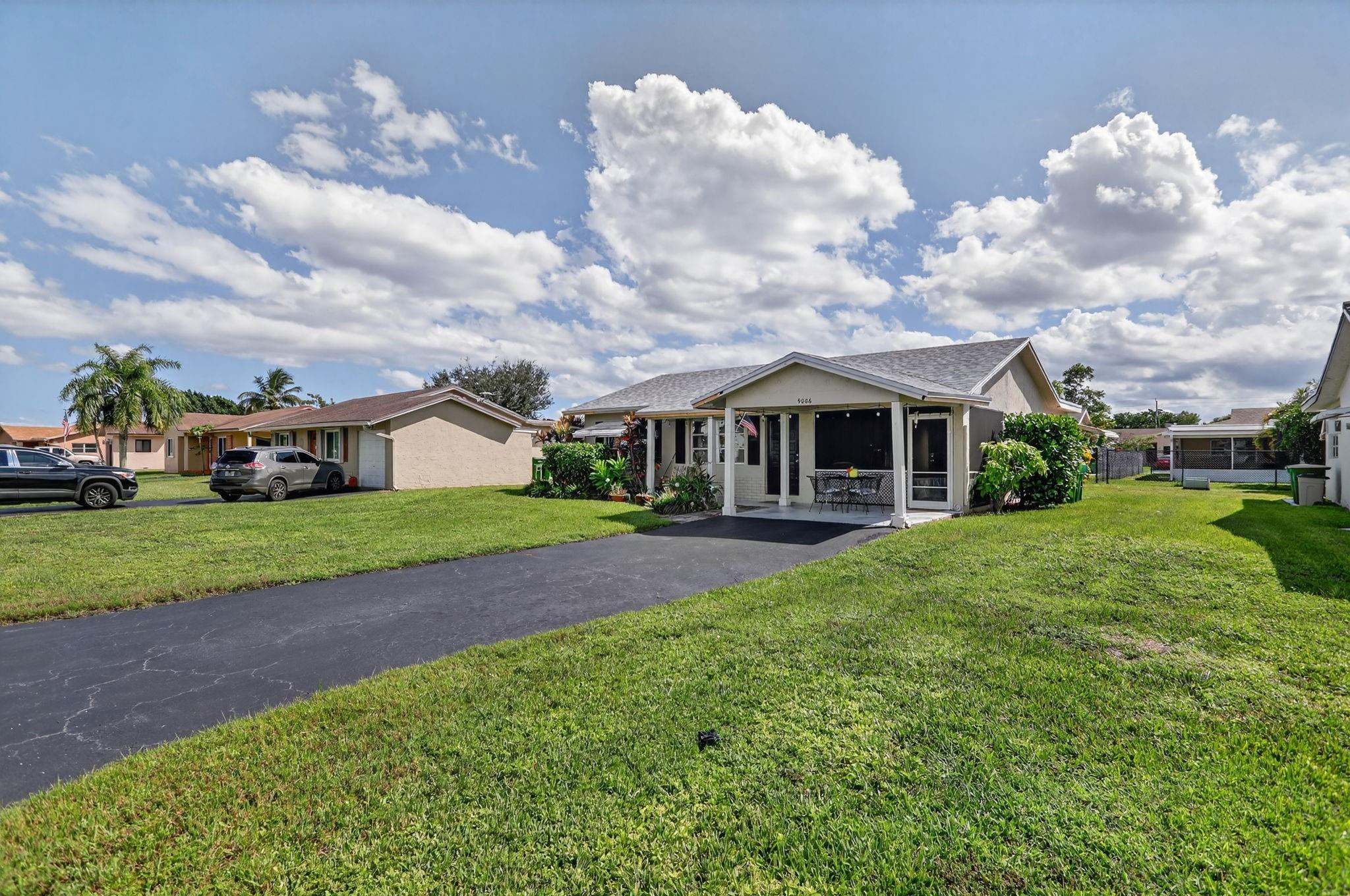 9806 Northwest 71st Street Tamarac, FL 33321 - Photo 22 of 23 a front view of a house with garden