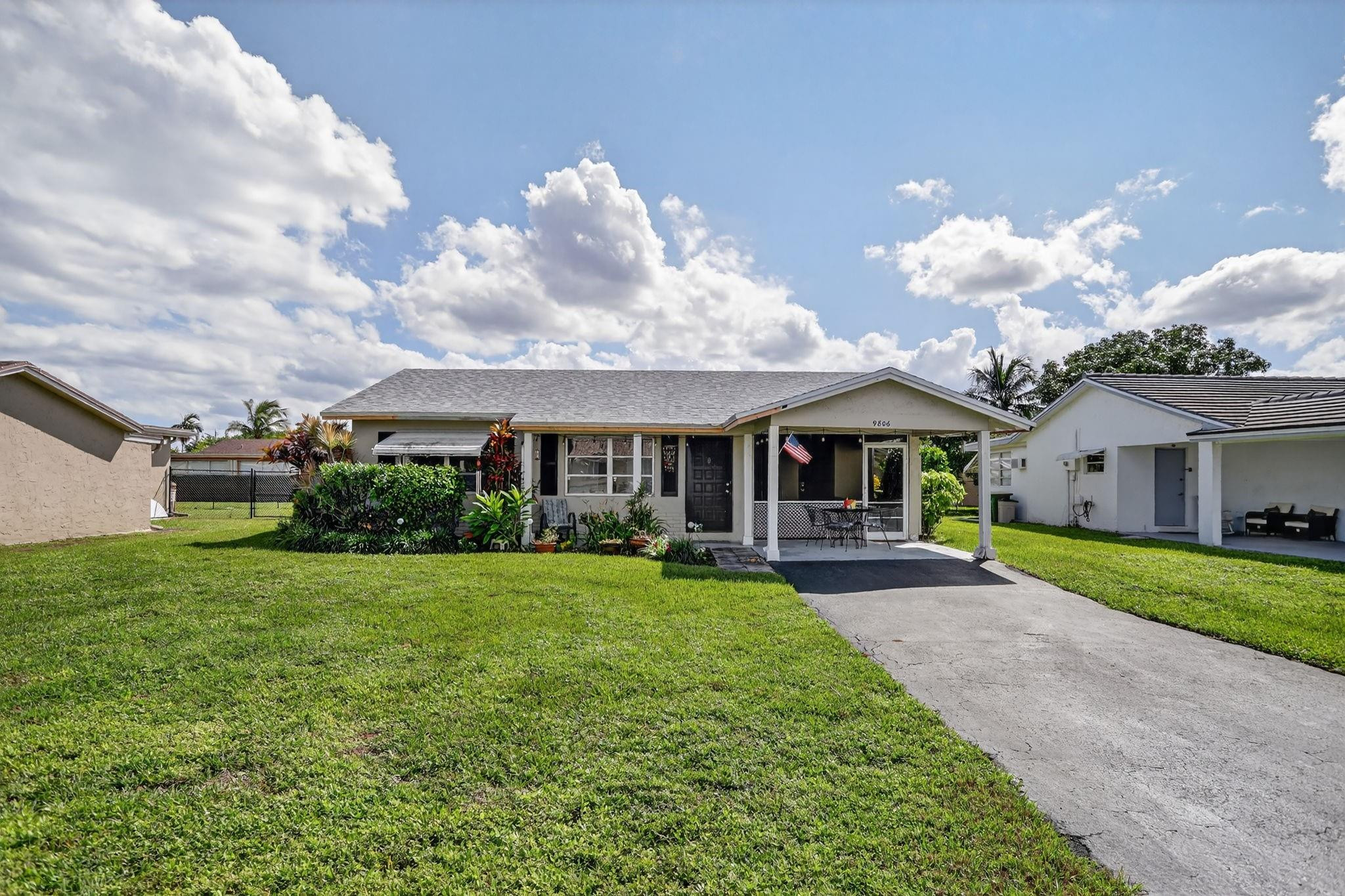 9806 Northwest 71st Street Tamarac, FL 33321 - Photo 3 of 23 a front view of a house with garden