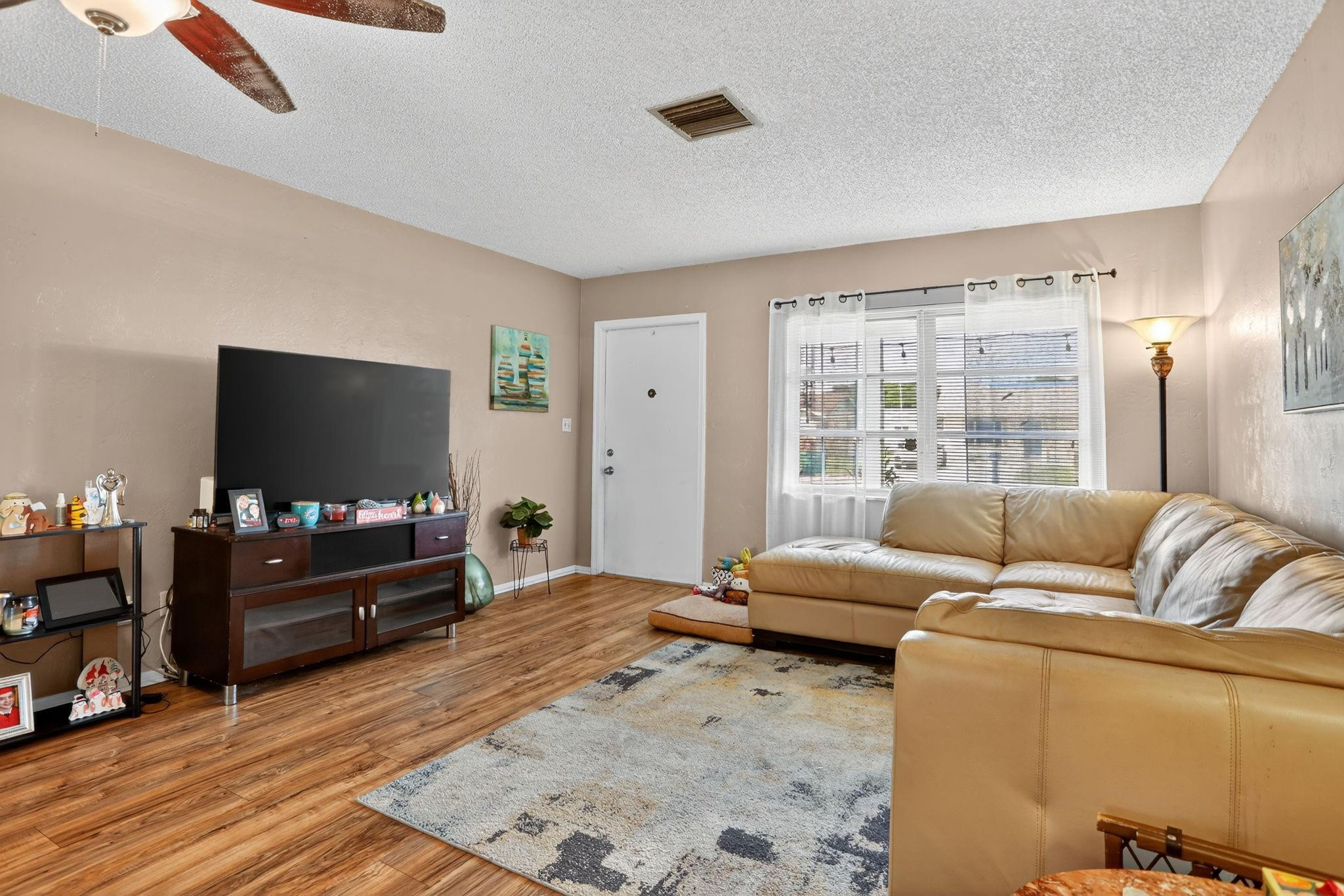 9806 Northwest 71st Street Tamarac, FL 33321 - Photo 6 of 23 a living room with furniture and a flat screen tv