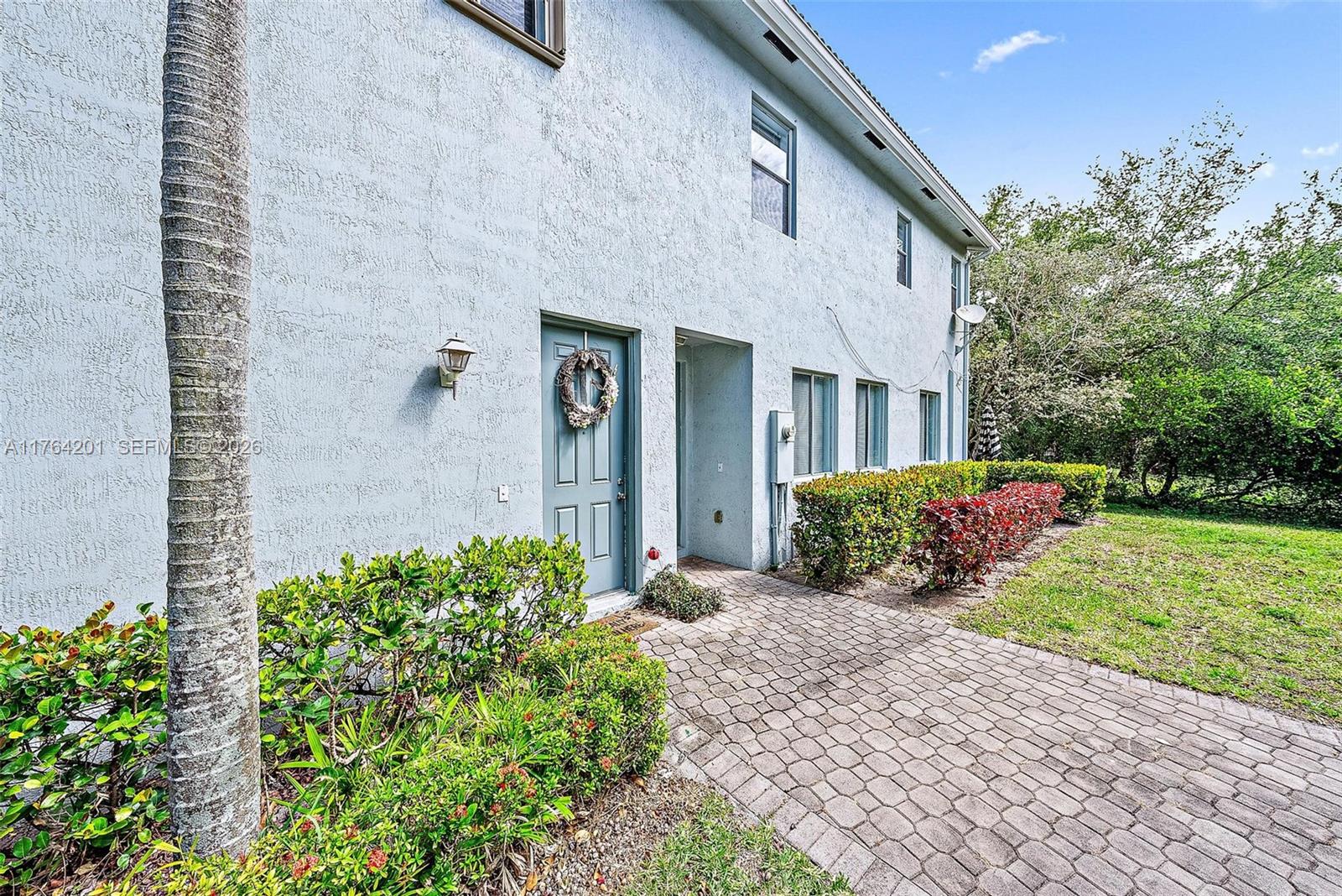 3229 Laurel Ridge Circle, Unit 3229 Riviera Beach, FL 33404 - Photo 23 of 24 a front view of a house with garden