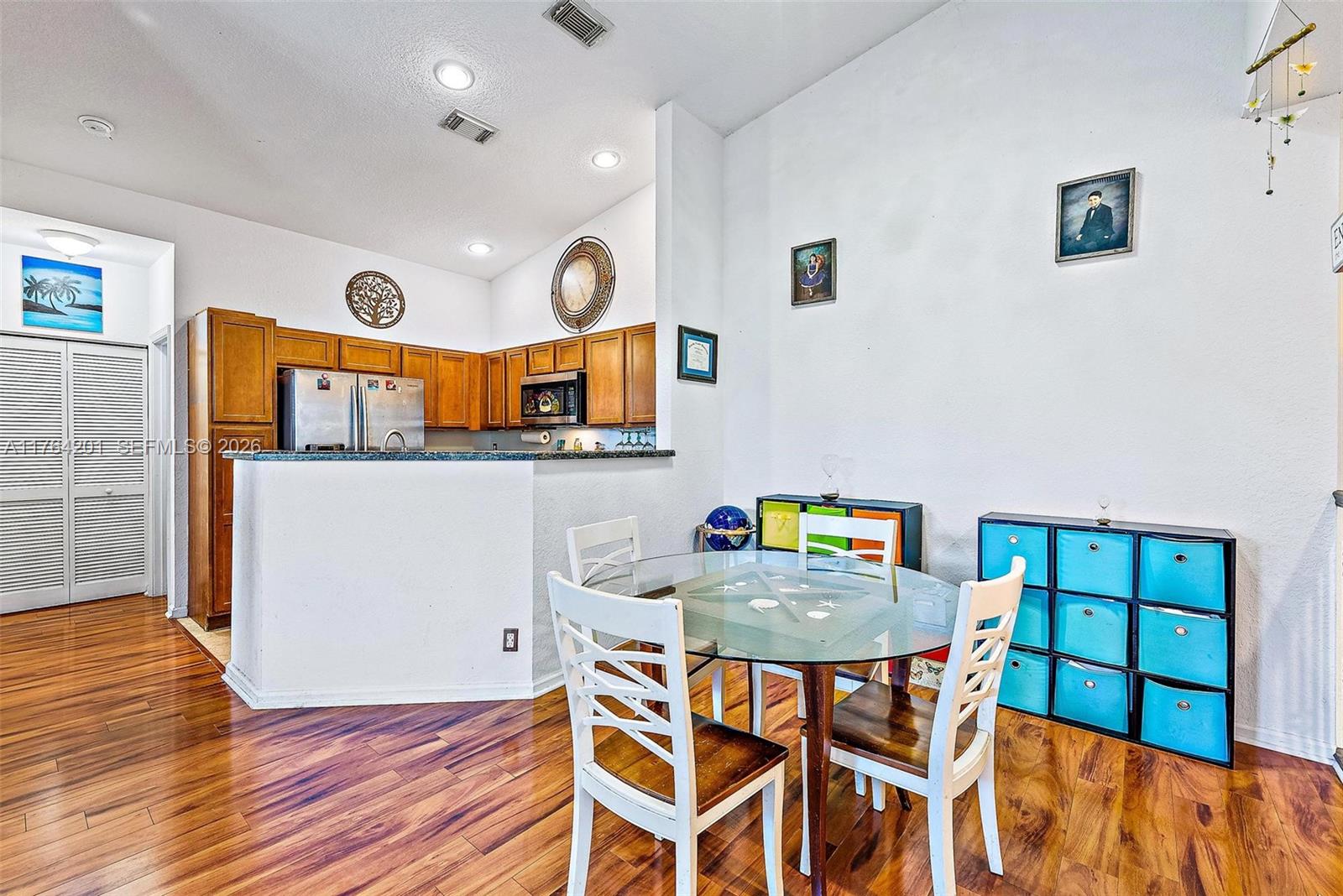 3229 Laurel Ridge Circle, Unit 3229 Riviera Beach, FL 33404 - Photo 5 of 24 a view of a dining room with furniture and wooden floor