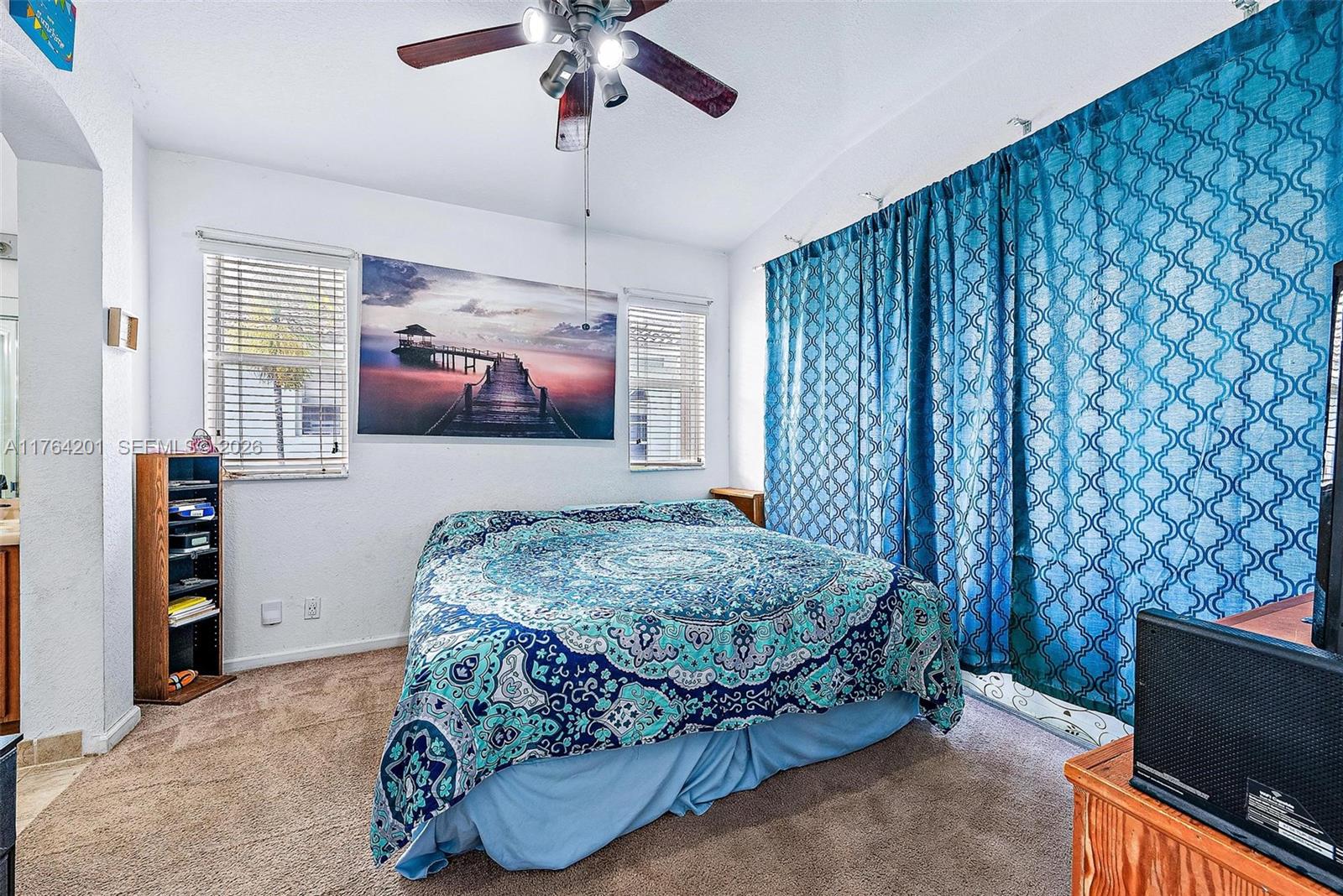 3229 Laurel Ridge Circle, Unit 3229 Riviera Beach, FL 33404 - Photo 8 of 24 a bedroom with a bed and a flat screen tv