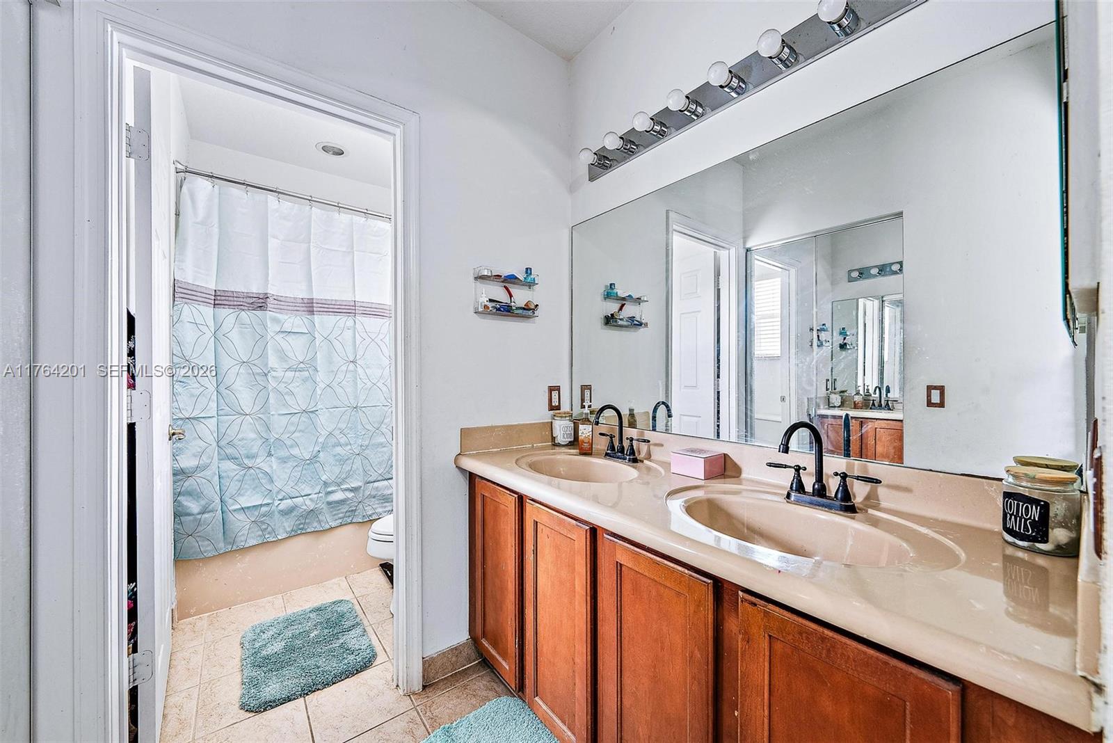 3229 Laurel Ridge Circle, Unit 3229 Riviera Beach, FL 33404 - Photo 9 of 24 a bathroom with a sink double vanity and a shower