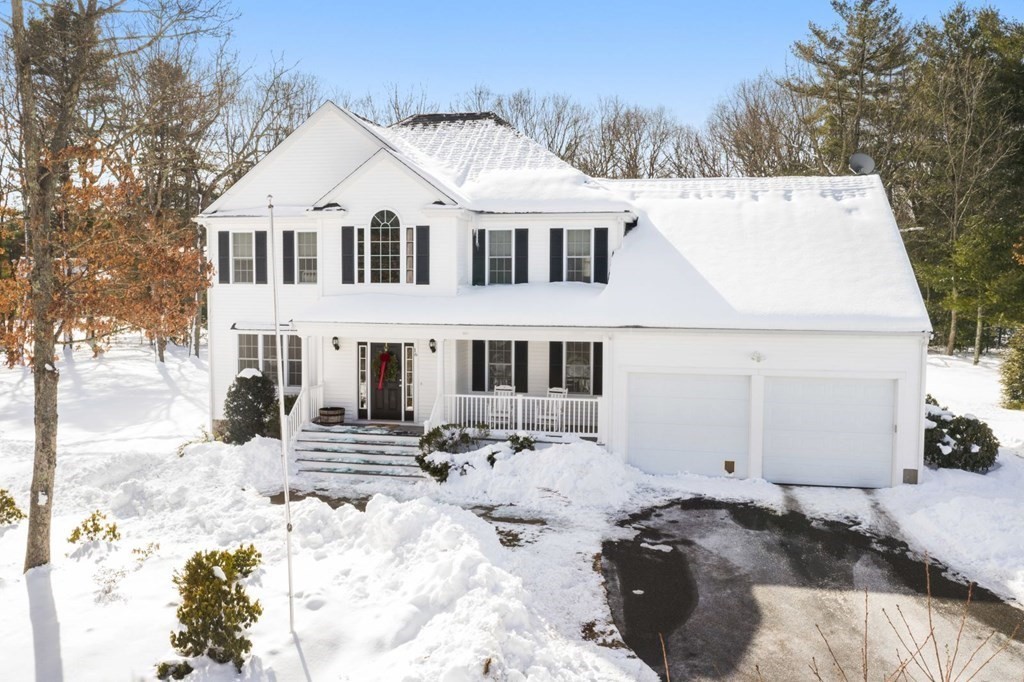 a view of a white house with snow on the background