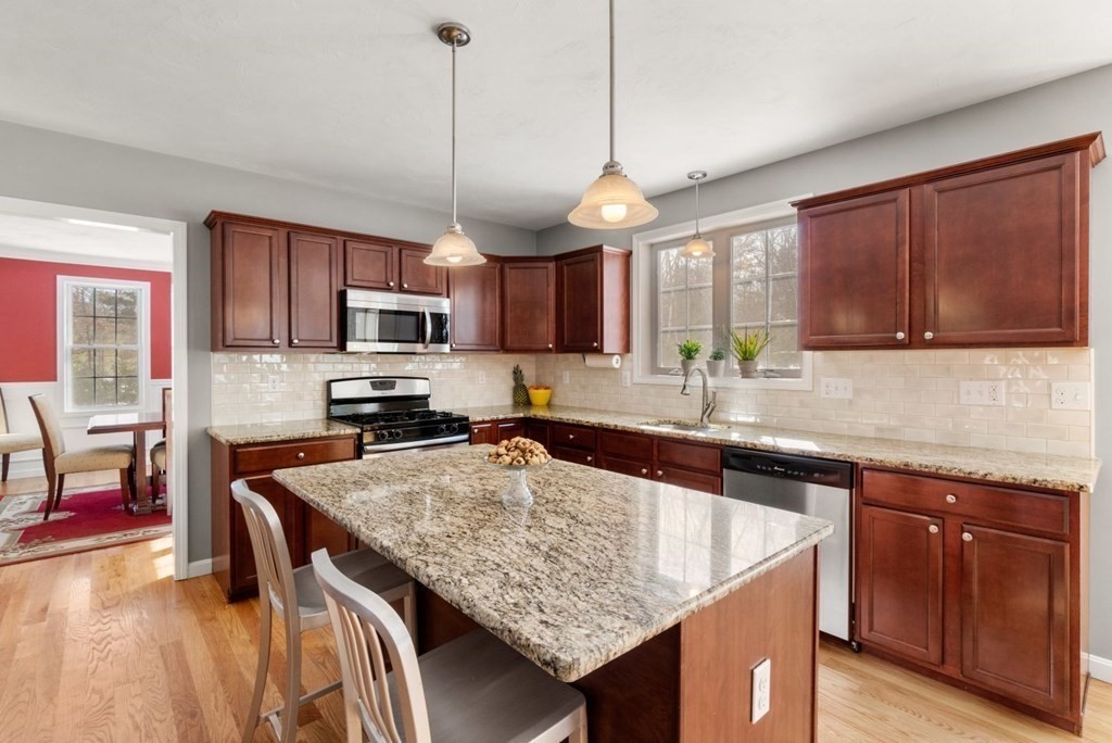 16 Michael Road Franklin, MA 02038 - Photo 12 of 39 a kitchen with stainless steel appliances granite countertop wooden cabinets granite counter tops and a view of living room