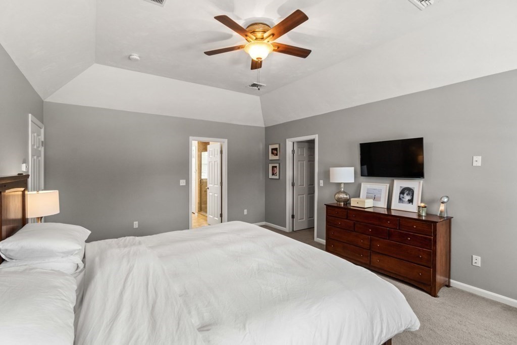 16 Michael Road Franklin, MA 02038 - Photo 21 of 39 a bedroom with a bed and a flat screen tv