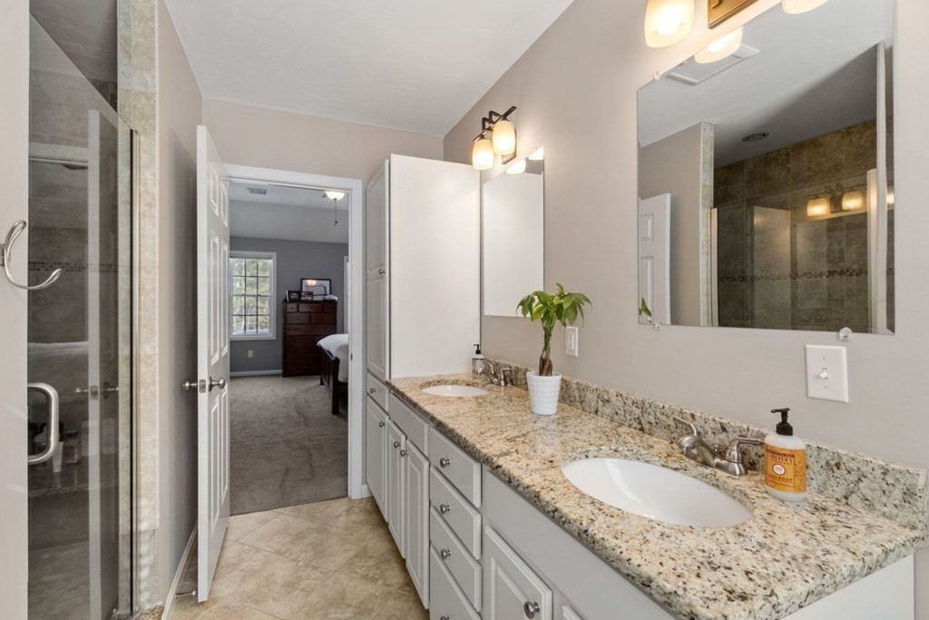 16 Michael Road Franklin, MA 02038 - Photo 23 of 39 a bathroom with a granite countertop sink double and mirror