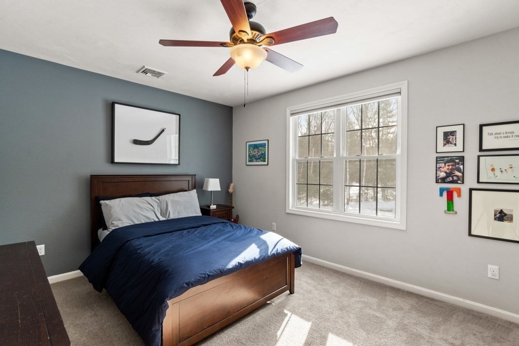 16 Michael Road Franklin, MA 02038 - Photo 28 of 39 a bed sitting in a bedroom next to a window