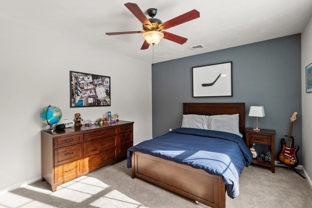 16 Michael Road Franklin, MA 02038 - Photo 29 of 39 a bedroom with a bed and a chandelier