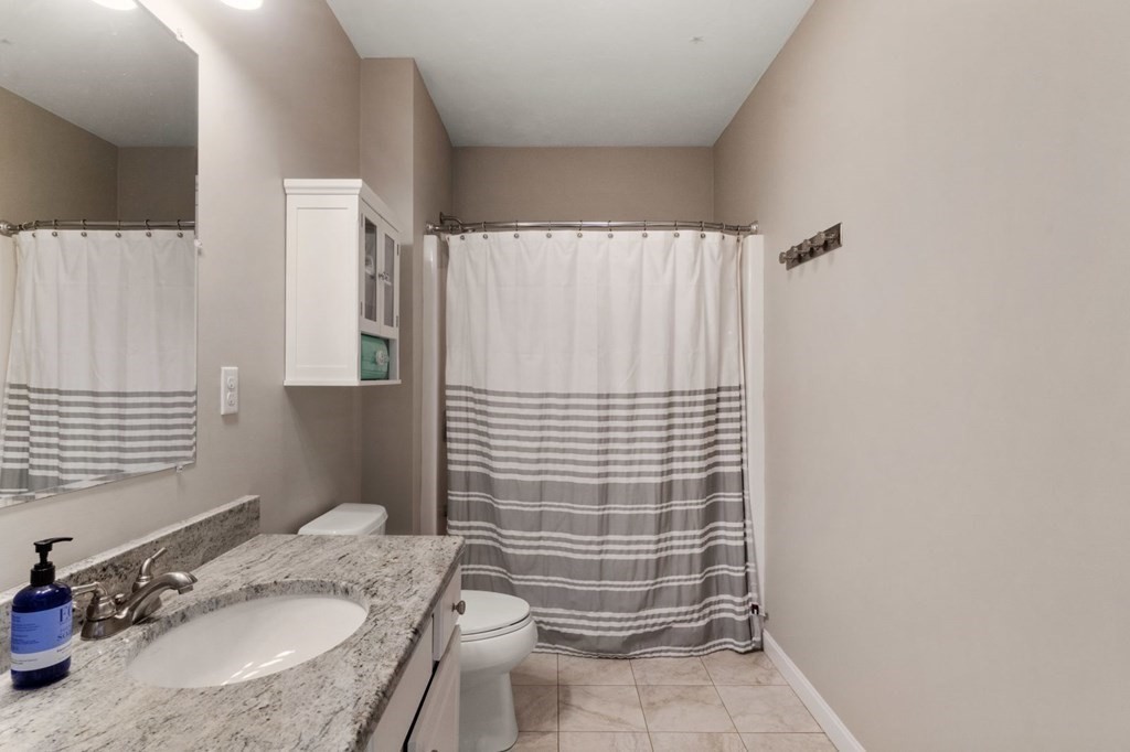 16 Michael Road Franklin, MA 02038 - Photo 31 of 39 a bathroom with a granite countertop sink toilet and shower