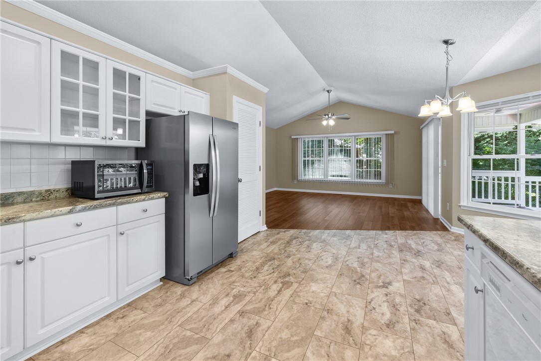 429 Burns Mill Road West Union, SC 29696 - Photo 15 of 49 A well-equipped kitchen transitions seamlessly to an open living area with vaulted ceilings.