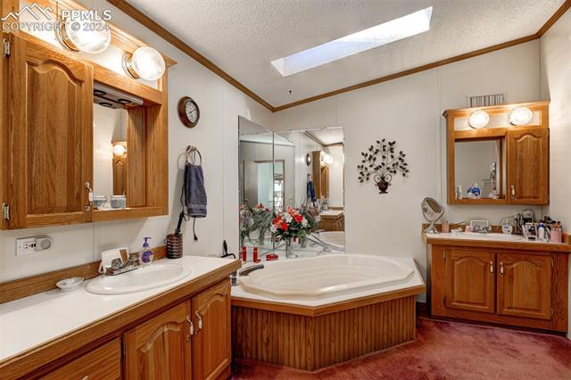 34170 Big Springs Road Yoder, CO 80864 - Photo 17 of 35 Ensuite Bathroom with garden tub, and 2 Vanities.