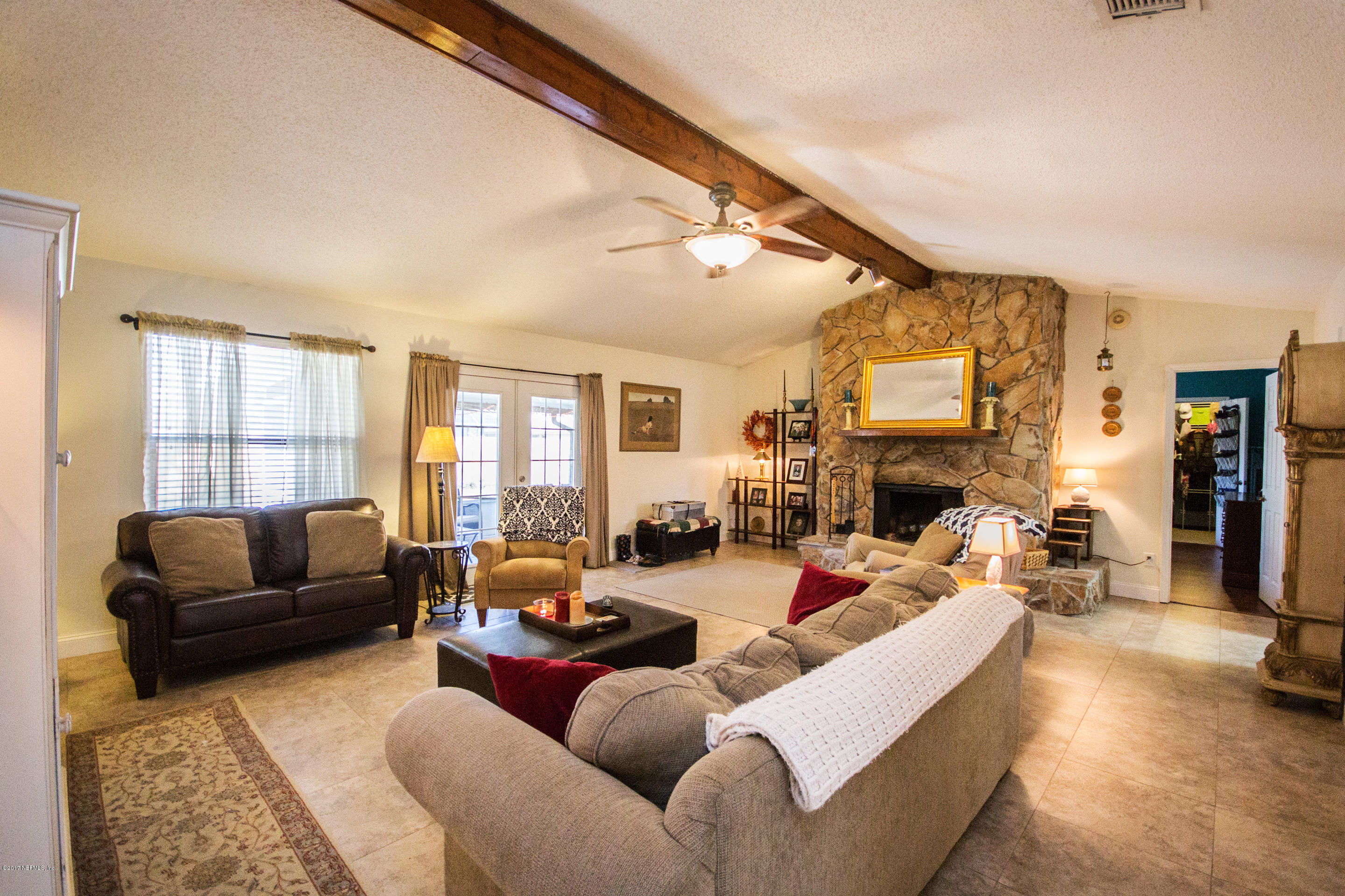 10934 Reading Road Jacksonville, FL 32257 - Photo 8 of 32 a living room with furniture fireplace and a flat screen tv