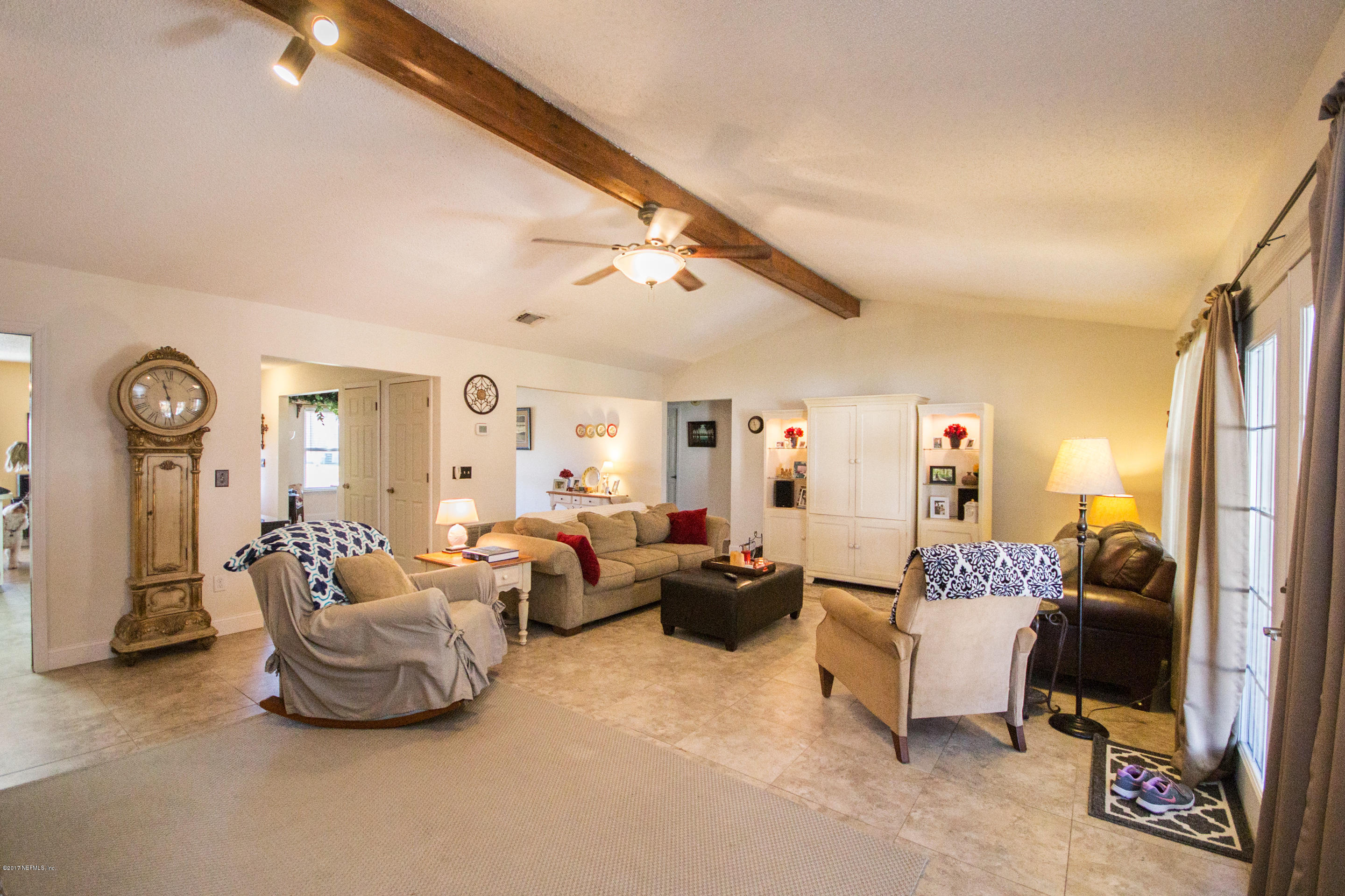 10934 Reading Road Jacksonville, FL 32257 - Photo 10 of 32 a living room with furniture and a chandelier