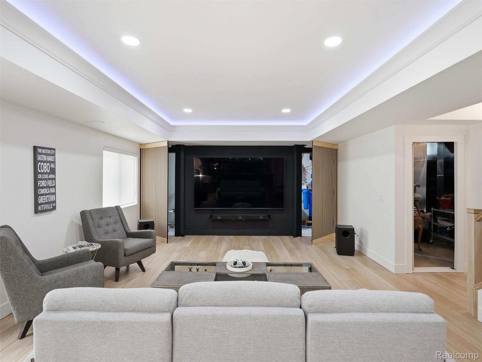 3007 28 Mile Road Washington, MI 48094 - Photo 45 of 69 Entertainment room with a large wall-mounted screen, light wood-finish flooring, and recessed ceiling lighting