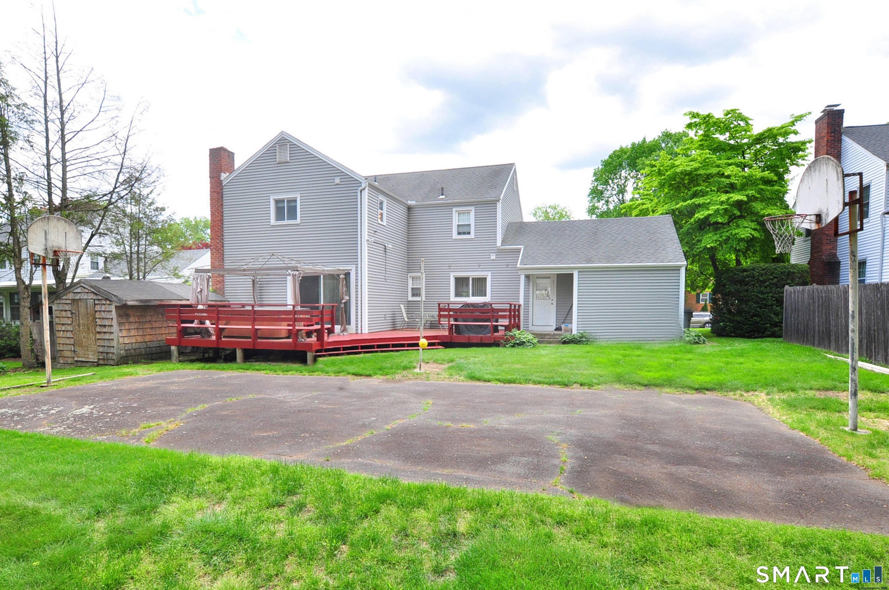 16 Miamis Road West Hartford, CT 06117 - Photo 35 of 39 This backyard has something for everyone! Deck, hot tub, basketball court and grassy area for play