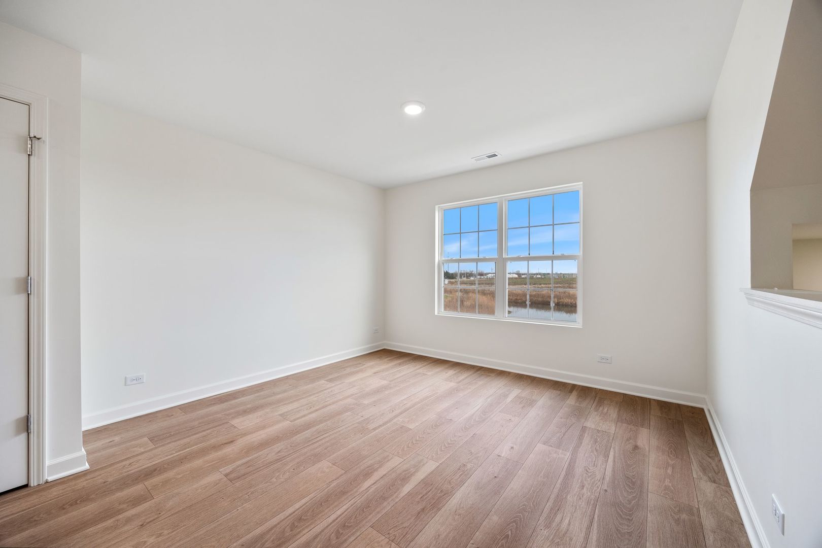 2463 BELLA Drive Pingree Grove, IL 60140 - Photo 11 of 24 a view of an empty room with wooden floor and a window