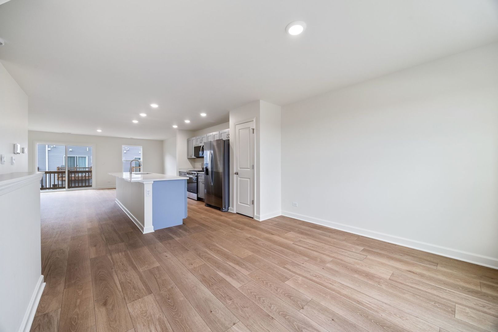 2463 BELLA Drive Pingree Grove, IL 60140 - Photo 13 of 24 a view of kitchen and empty room with wooden floor