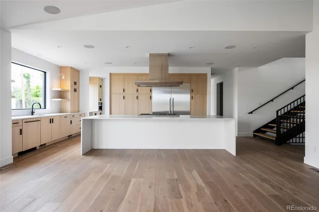 a kitchen with stainless steel appliances a sink and a stove