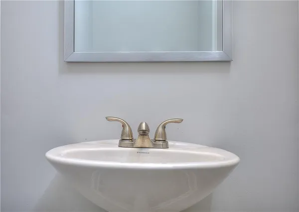 a close view of sink a mirror and vanity