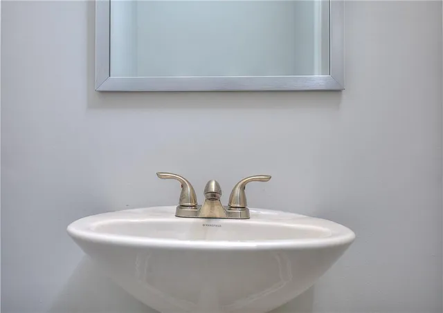 a close view of sink a mirror and vanity