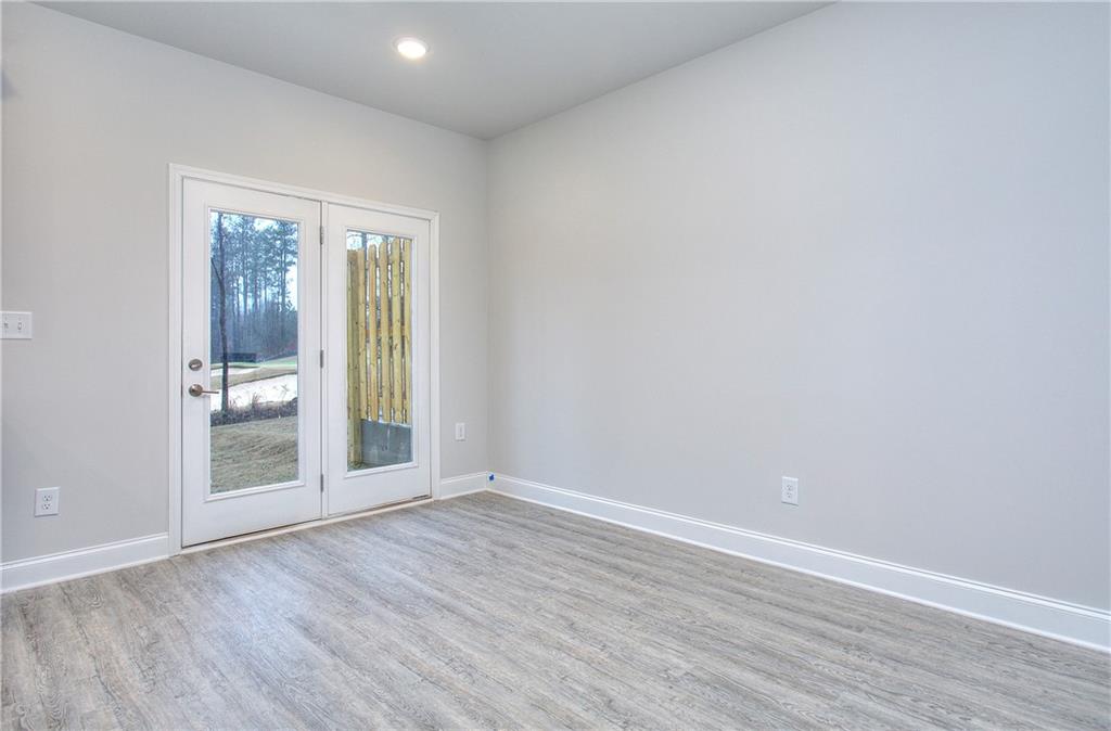 104 Greenview Court Homer, GA 30547 - Photo 2 of 33 an empty room with wooden floor and windows