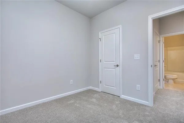 a view of an empty room and closet area