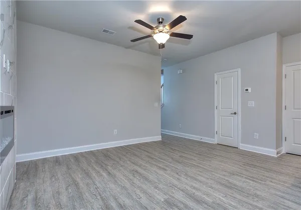 a view of an empty room with wooden floor