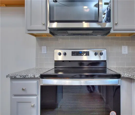 a stove top oven sitting inside of a kitchen