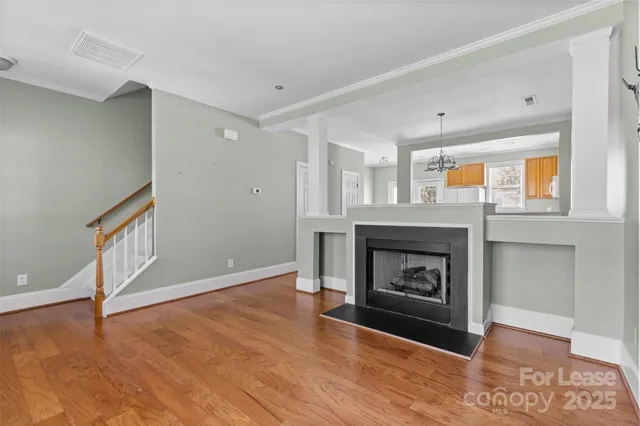 a view of an empty room with a fireplace and a window