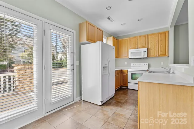 a kitchen with a refrigerator a sink and a stove