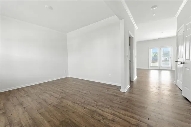 a view of a room with wooden floor
