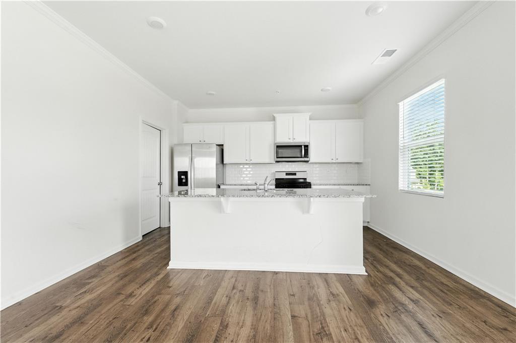 6753 Chilkat Court Southwest Atlanta, GA 30331 - Photo 5 of 16 a view of kitchen with wooden floor and electronic appliances